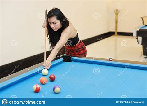 Young Beautiful Asian Woman Playing And Aiming For Billiards Ball On
