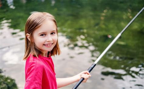 Premium Photo Little Girl Holding Fishing Rod On Pond Background