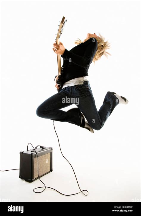 Woman Excitedly Playing Electric Guitar Stock Photo Alamy
