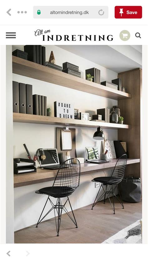Two Black Chairs Sitting On Top Of A Wooden Shelf Next To A Bookcase