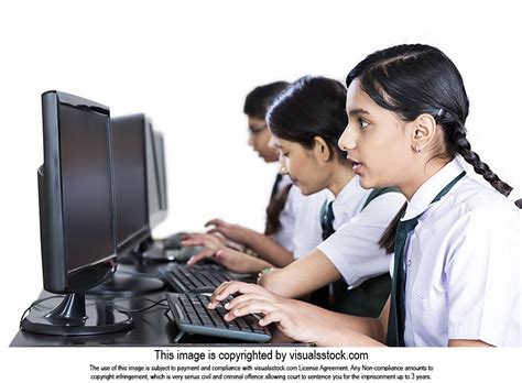 Indian School Students Looking At Computer At Work Studying E Learning