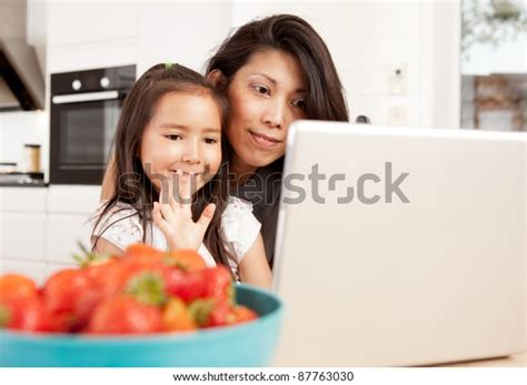 Computer wave are versatile enough to be worn by virtually anyone, including women, men, and kids of all ethnicities and ages. Mother Daughter Using Computer Waving While Stock Photo ...