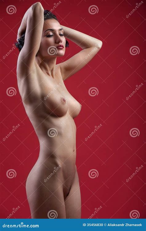 Beautiful Naked Girl Posing On A Red Background Stock Photo Image
