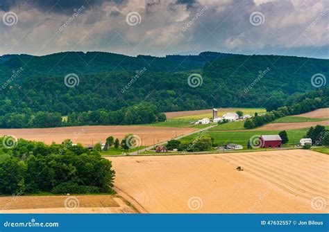 View Of Farm Fields And Distant Mountains From A Roadside Overlook Near