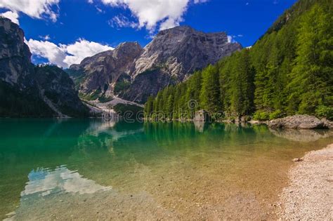Braies Lake Is Surrounded By The Dolomites Which Are Reflected In The