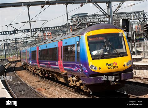 Class 170 Turbostar Train In First Transpennine Express Livery Arriving At A Railway Station In