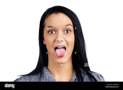 Funny And Humorous Portrait Of A Beautiful Young Woman Making Face By Sticking Her Tongue Out