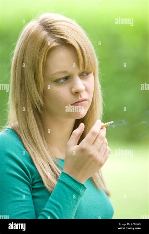 Teenage Girl Smoking A Cigarette Outside Stock Photo Alamy