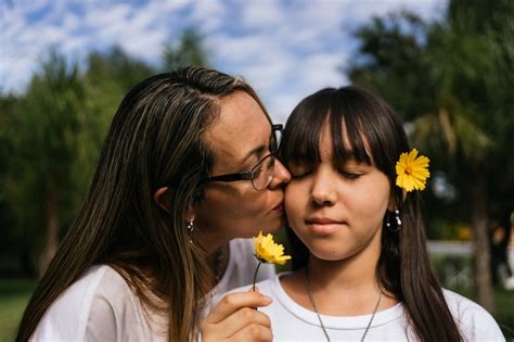 Premium Photo Portrait Of Latina Mother And Daughter Kissing Each Other