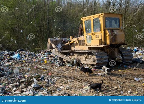 Bulldozer At Landfill For Work Concrete Demolition Waste Salvaging And