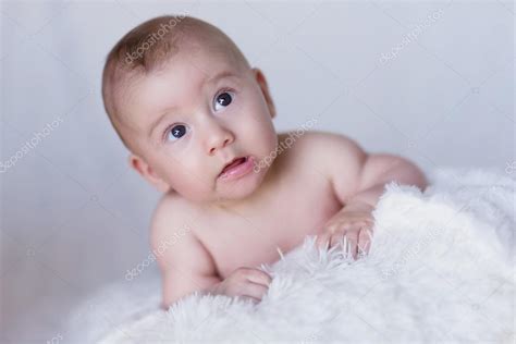 Naked Newborn Baby Lying On Blanket And Looking Up Curiousl Stock