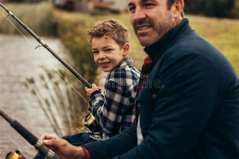 Close Up Of Father And Son Fishing Near A Lake Stock Photo Image Of