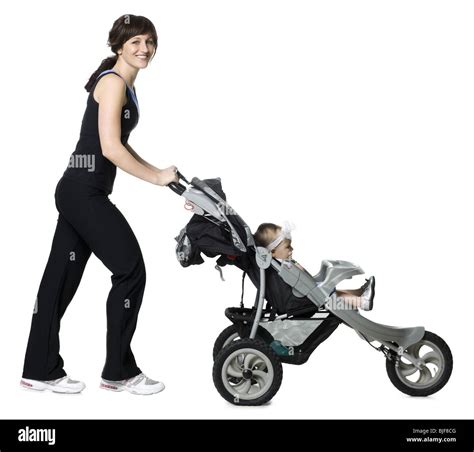Woman Pushing Her Baby In A Stroller Stock Photo Alamy