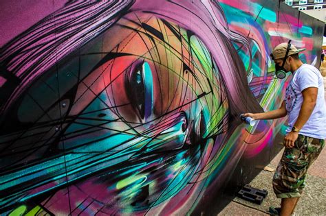 Street Artist Hopare At Work On One Of His Colorful Graphic Design Influenced Graffiti Murals Of