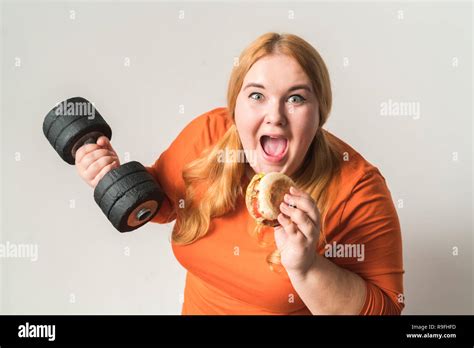 Chubby Woman Sport At Home Standing Isolated On White Wall Holding