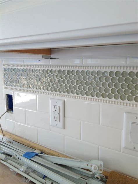 White Penny Tile Incorporate Into Subway Tiles With Border