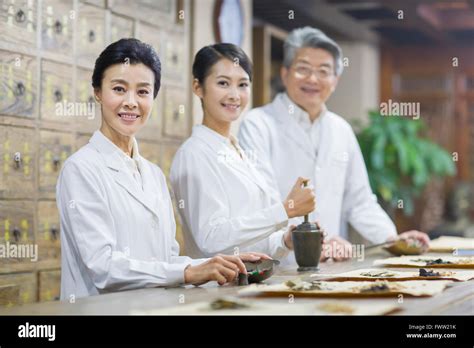 Chinese Doctors In Traditional Chinese Medicine Pharmacy Stock Photo