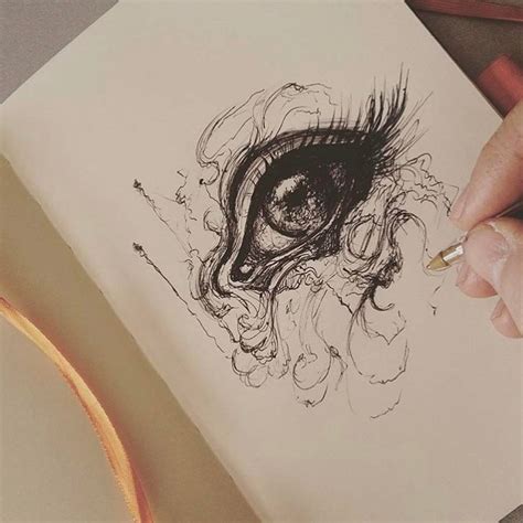 A Persons Hand Is Holding A Pencil And Drawing An Eye