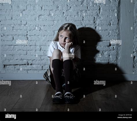 Sad Girl Sitting Against Wall