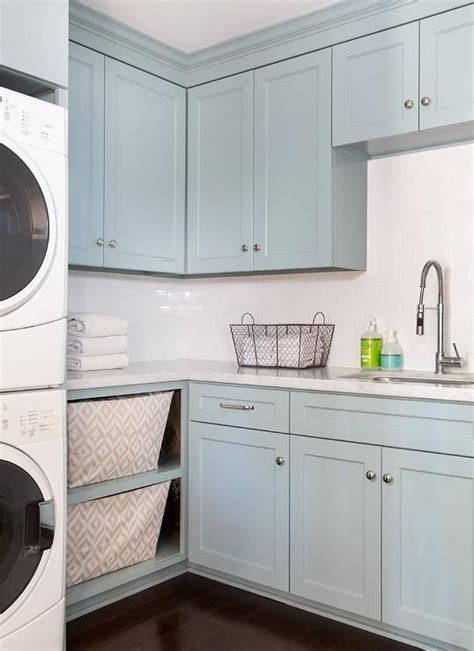 Laundry rooms are essential to any home, but their organizational needs can often get overlooked. Blue laundry room features blue shaker cabinets paired ...