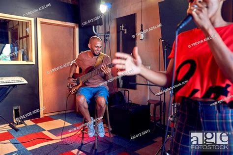 Musicians Singing And Playing Guitar In Recording Studio Stock Photo