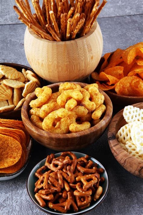 Salty Snacks Pretzels Chips Crackers In Wooden Bowls Stock Photo