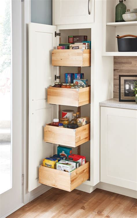 Under cabinet storage like hanging wine glass racks set stemware upside down to make use of vertical space and keep dust out. A tall pantry with deep drawers makes achieving a well ...