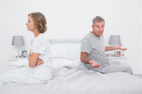 Premium Photo Couple Sitting On Different Sides Of Bed Having A Dispute