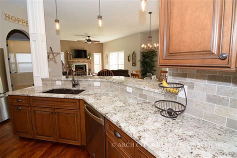 Depending on your style, you can use backsplash and accessories to make this the centerpiece of either a traditional or contemporary kitchen. White granite color paired with medium maple cabinets and ...