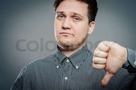 Disappointed Young Man Showing Thumb Down Sign Stock Image Colourbox