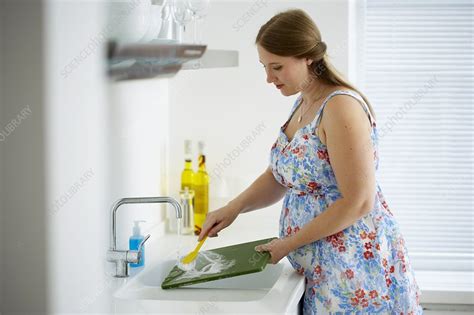 Pregnant Woman Washing Dishes In Kitchen Sink Stock Image C0541250 Science Photo Library