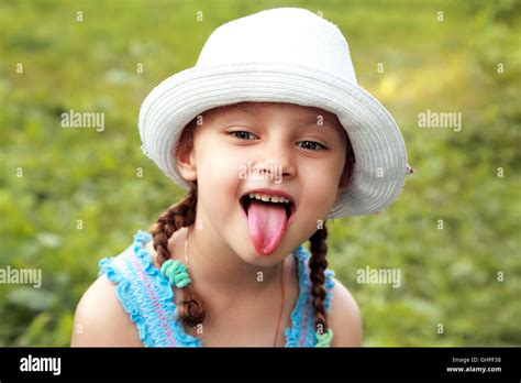 Fun Kid Girl In Fashion Hat Showing The Tongue With Humor Face On