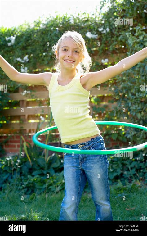 Girl Playing With A Hula Hoopshe Is Eight Years Old Stock Photo