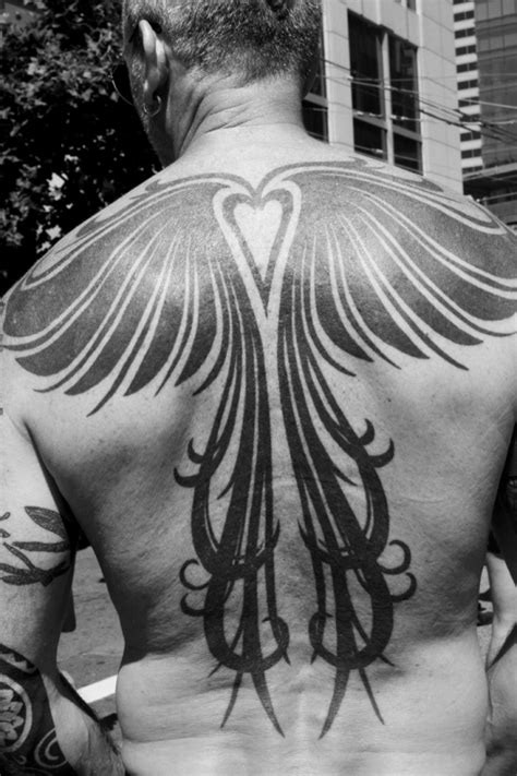 Tribal open wings phoenix tattoo on upper back. 35 Awesome Manly Tattoos for Men... (very cool)