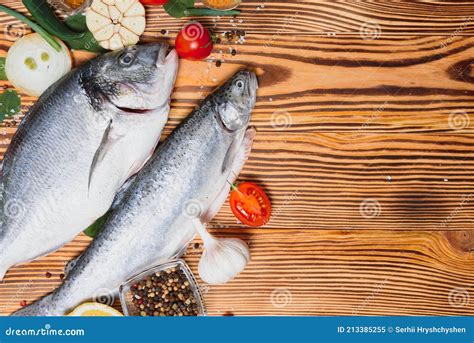 Raw Dorado And Trout Fish With Spices Cooking On Cutting Board Fresh