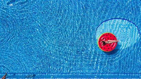 Aerial View Of Female In Bikini Lying On A Floating Mattress In Swimming Pool Summer Vacation