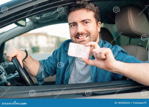 Cheerful Man Holding Driver License In His Car Stock Photo Image Of