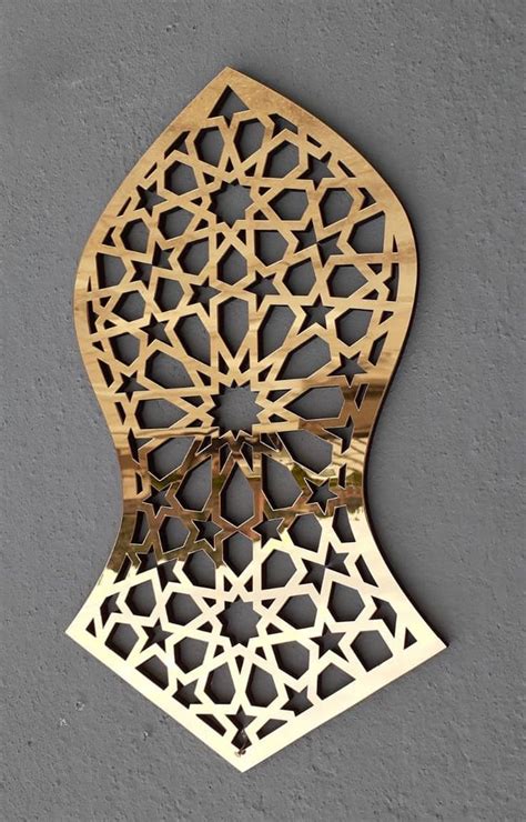 An Intricate Wooden Wall Hanging On The Side Of A Gray Wall With