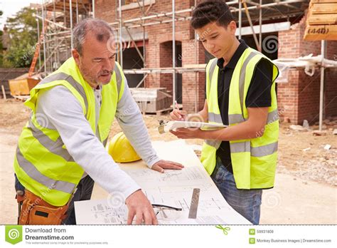 Do you have the tools you need to get a construction job? Builder On Building Site Discussing Work With Apprentice ...