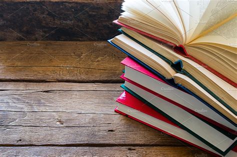 Open Book On A Stack Of Closed Books School And Education Stock Photos