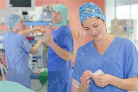 Nurse In Scrubs Preparing For Operation In Hospital Theatre Photo