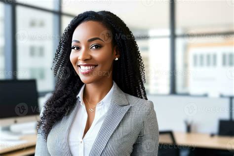 Young Smiling Businesswoman Standing In Blur Background Of Office