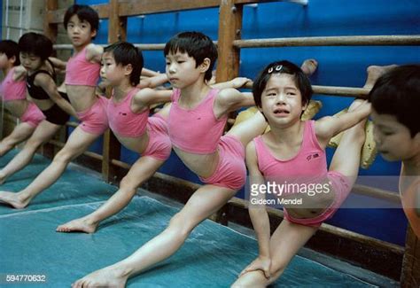 Young Gymnasts Do A Muscle Stretching Exercise At The Start Of Their