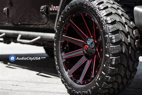 The Wheel And Tire Of A Jeep With Red Spokes On Its Tires