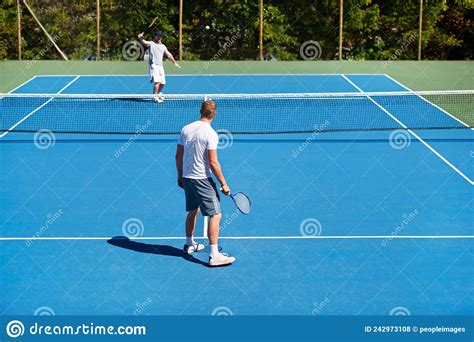 The Game Is On People Playing Tennis On A Tennis Court Stock Photo