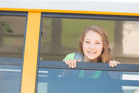 school bus pretty girl looks out bus window del colaborador de stocksy sean locke stocksy