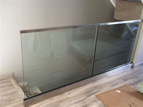 Minimalist glass railing for dark wood staircase. Glass Stairway Railing Installation - Patriot Glass and ...