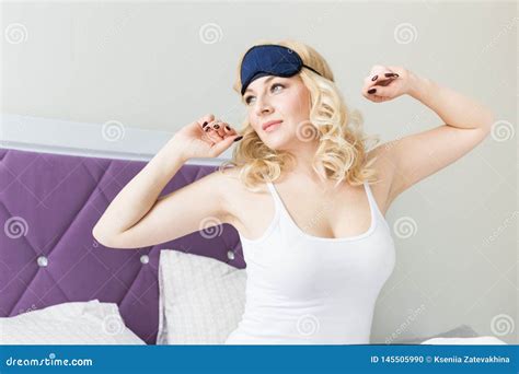 A Beautiful Blonde Woman Wakes Up And Snares A Mask For Sleeping In Her