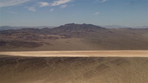 4k Stock Footage Aerial Video Approach A Dry Lake Near Mojave Desert