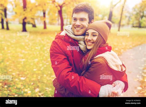 Happy Young Couple Hugging In Autumn Park Stock Photo Alamy
